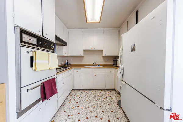 a kitchen with a refrigerator and a stove