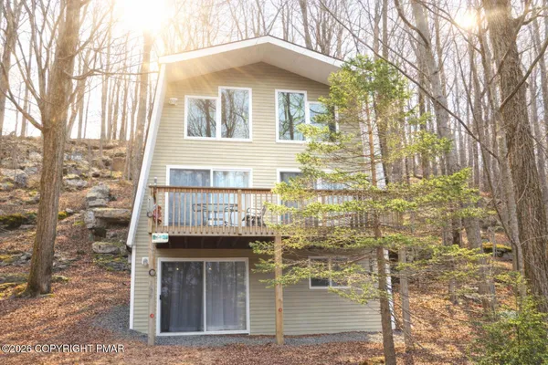 a glass building with a yard