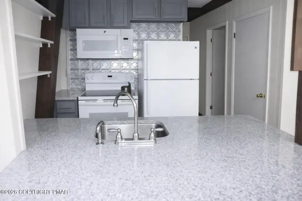 a view of a dining room with furniture and window