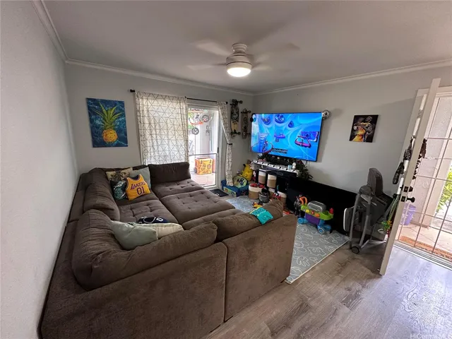 a living room with furniture and wooden floor