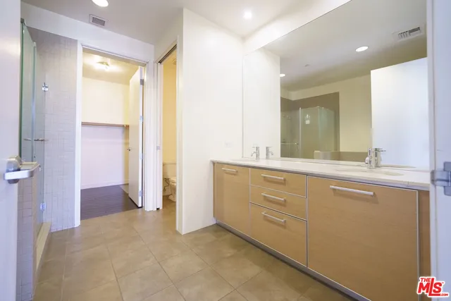 a bathroom with a granite countertop sink mirror and double