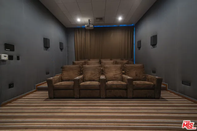 a media room with lots of chairs and a projector screen