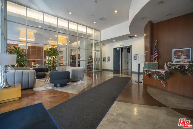 a living room with furniture a flat screen tv and a large window