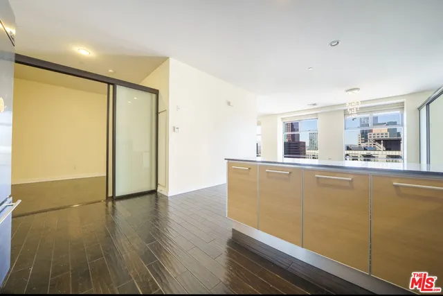 a view of a kitchen with wooden floor and a window