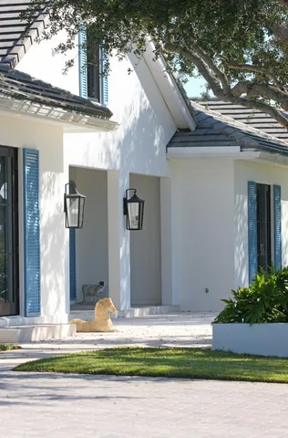 a view of a house with a yard garage and tree