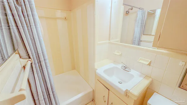 a bathroom with a sink a mirror and a shower
