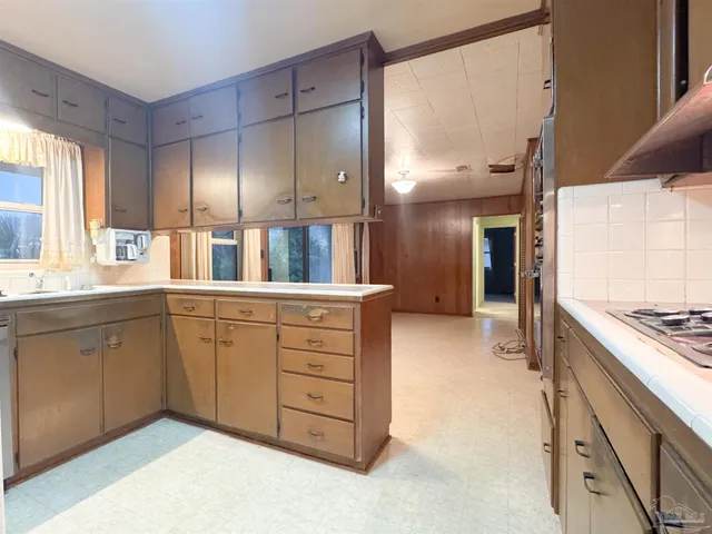 a spacious bathroom with a granite countertop sink a mirror and a shower