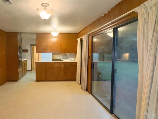 a view of a kitchen with a refrigerator and a window