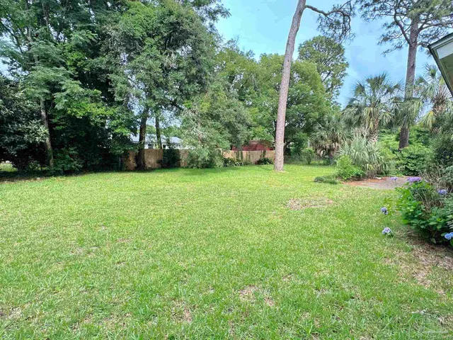 a view of a trees with a house in the background