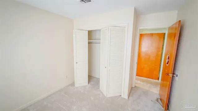 a view of an empty room and a window