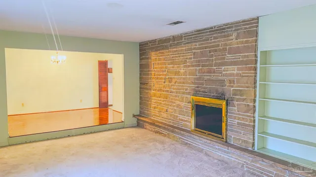 a view of an empty room with a fireplace