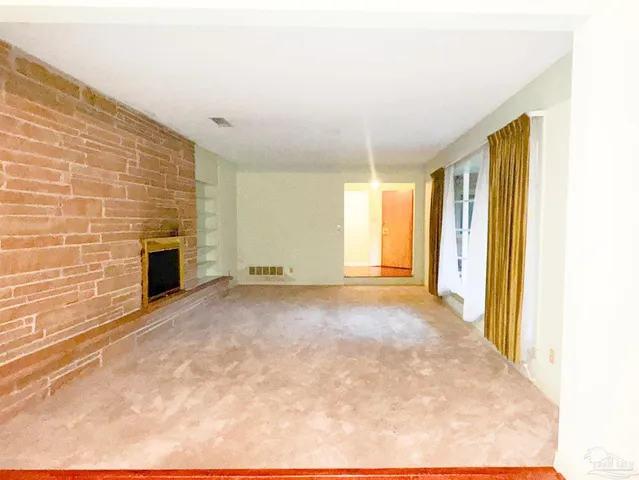a view of empty room with a fireplace