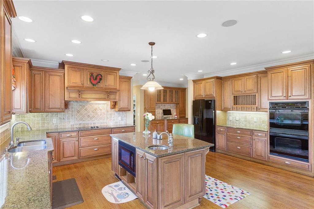 4237 Rock Bridge Road High Point, NC 27262 - Photo 12 of 30 Exquisite cabinetry, granite, tumbled stone backsplash. Double ovens.
