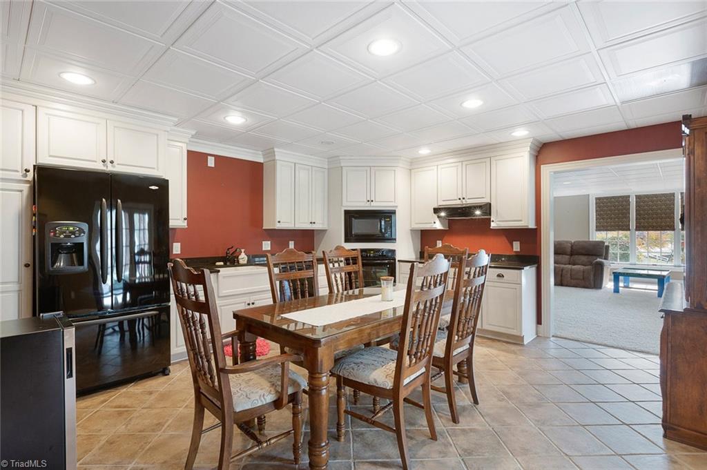 4237 Rock Bridge Road High Point, NC 27262 - Photo 25 of 30 Lower level kitchen with fridge, dishwasher, oven, cooktop, wine fridge and pantry.