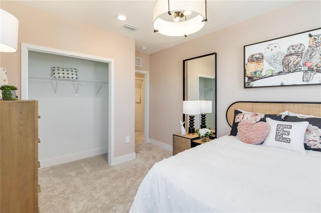 1077 Orange Trailside Way Ocoee, FL 34761 - Photo 29 of 30 a bedroom with a large bed and a painting on the wall