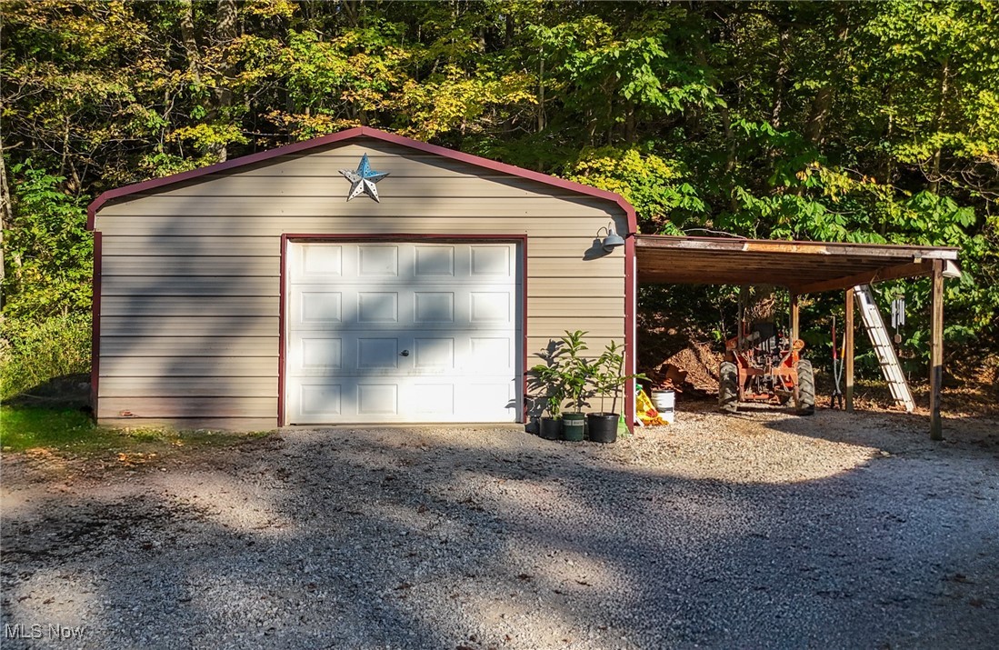 1788 Rosenbush Road Newport, OH 45768 - Photo 9 of 34 Garage with a lean to and gravel driveway