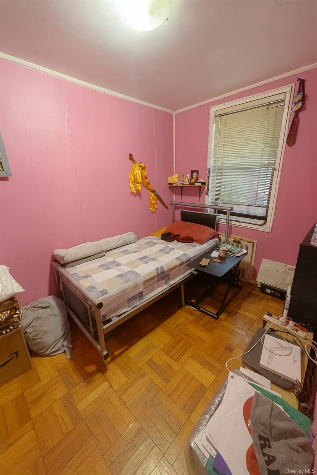 86-04 Grand Avenue, Unit 2D Queens, NY 11373 - Photo 4 of 13 a bedroom with a bed and wooden floor