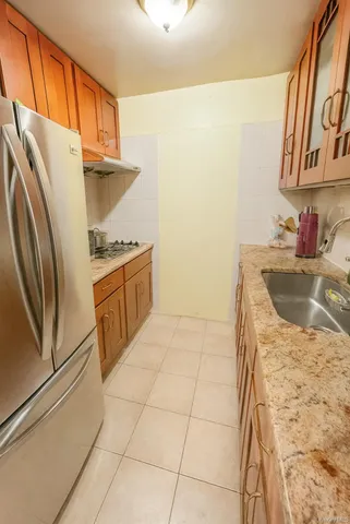 a kitchen with granite countertop a sink a stove a refrigerator and washer