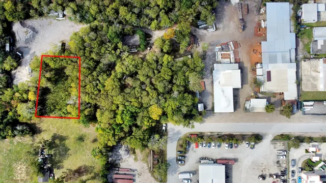 an aerial view of a residential apartment building with a yard