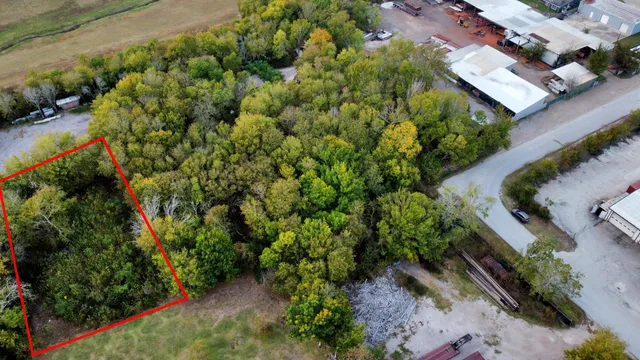 an aerial view of a house with a yard and garden