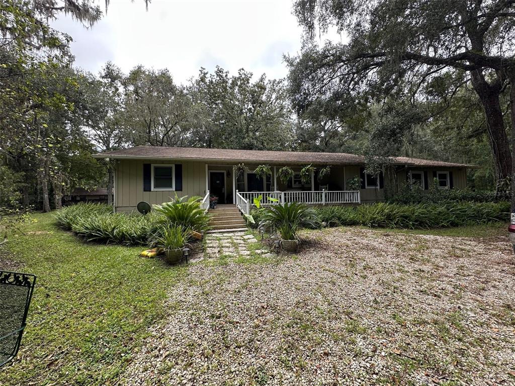 a view of a house with backyard sitting area and garden