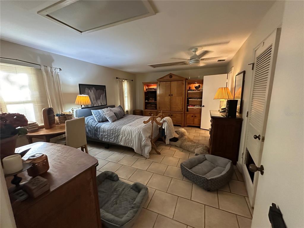 24392 Lanark Road Brooksville, FL 34601 - Photo 33 of 58 a living room with furniture and a flat screen tv