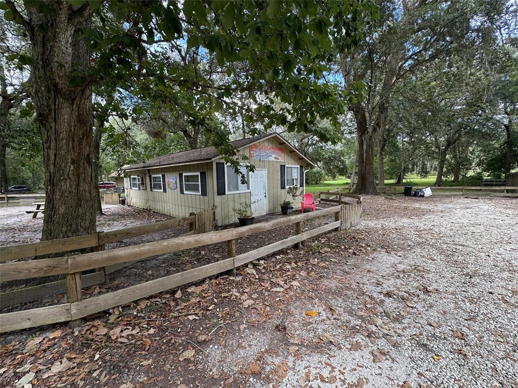24392 Lanark Road Brooksville, FL 34601 - Photo 8 of 58 a front view of a house with wooden stairs