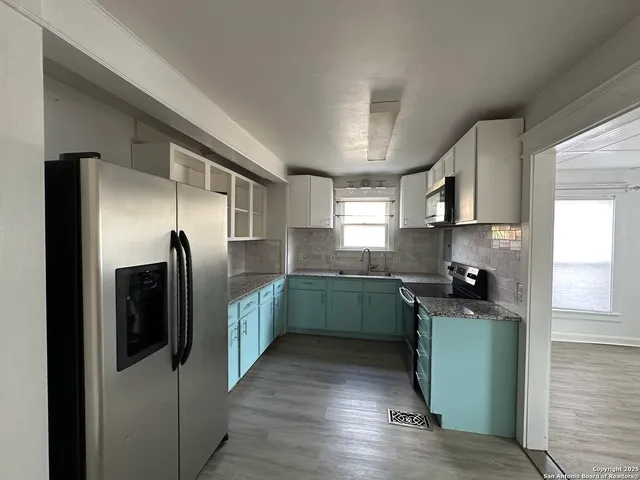 a kitchen with a refrigerator and a sink