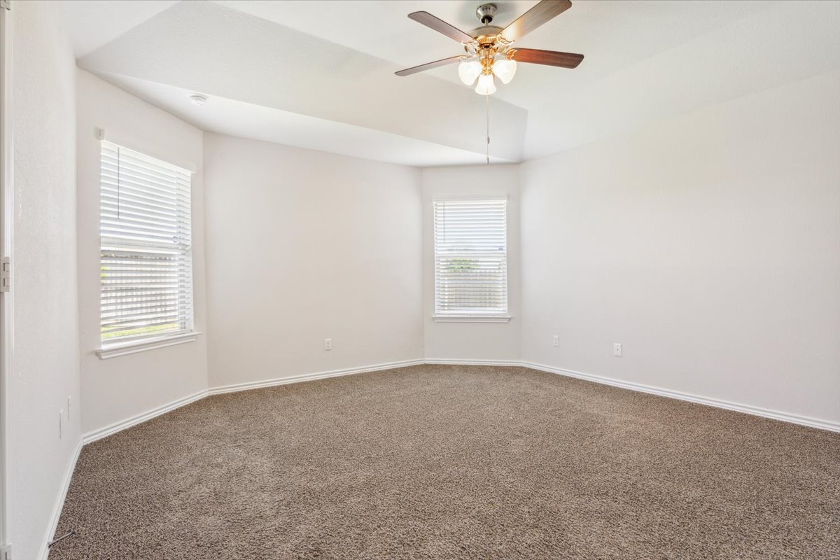 5830 Copano Road Belton, TX 76513 - Photo 18 of 34 Carpeted spare room featuring ceiling fan, baseboards, and a healthy amount of sunlight