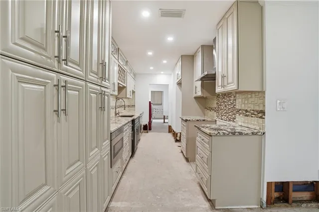 a kitchen with stainless steel appliances granite countertop a stove and a refrigerator