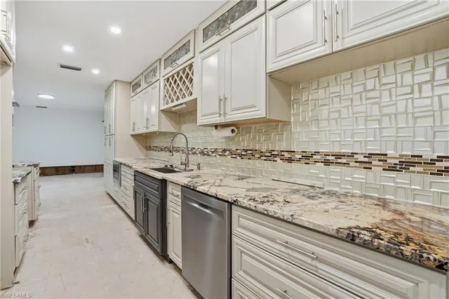a kitchen with stainless steel appliances granite countertop a sink and cabinets