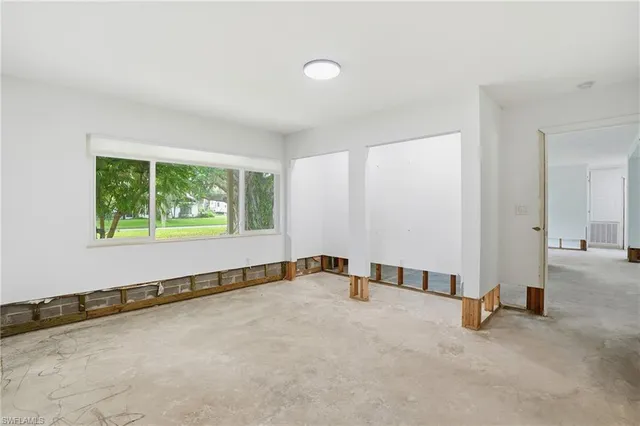 a view of a room with gym equipment and windows
