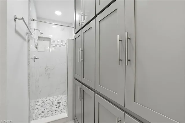 a bathroom with a shower and a glass door