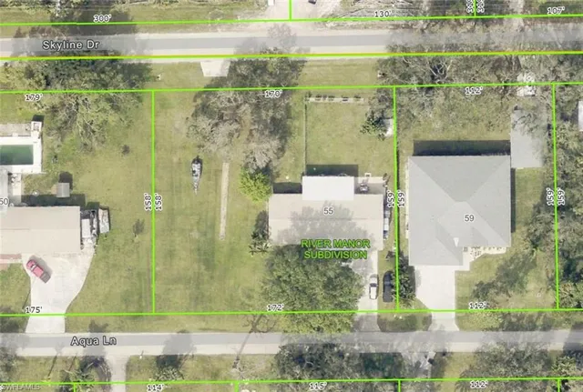 an aerial view of residential houses with outdoor space and swimming pool