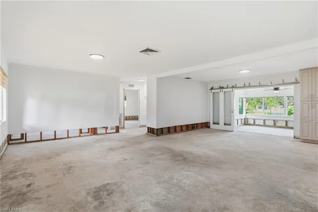a view of a room with window and a view of empty room