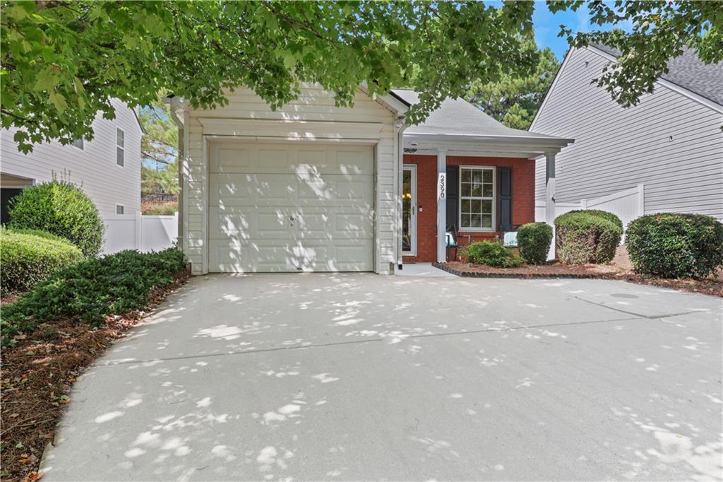 2390 Keenland Court Cumming, GA 30040 - Photo 1 of 1 a front view of a house with garden