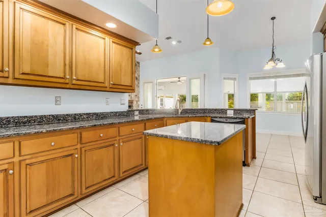 a kitchen with stainless steel appliances granite countertop a sink and a stove