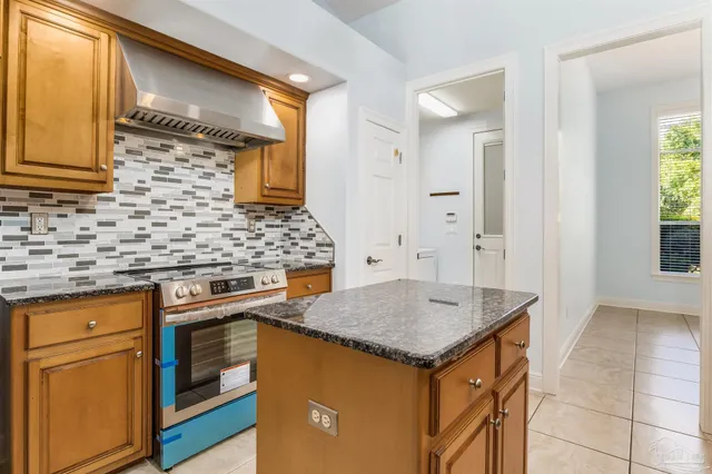 a kitchen with stainless steel appliances granite countertop a sink and a refrigerator