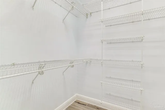 wooden floor in an empty room with a fan