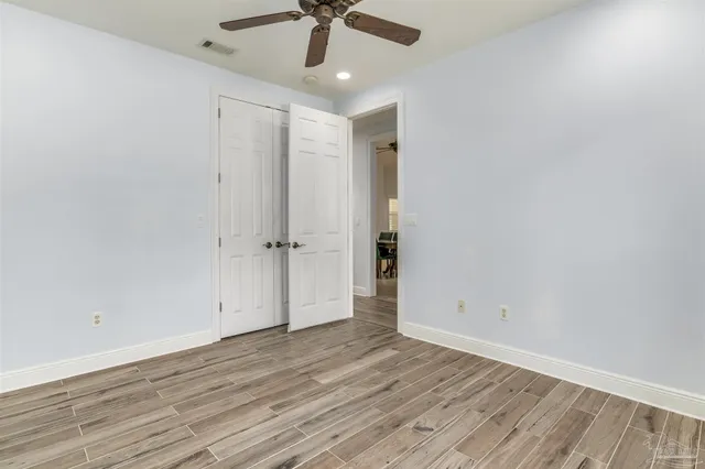 a view of a dining room and livingroom with furniture wooden floor a chandelier
