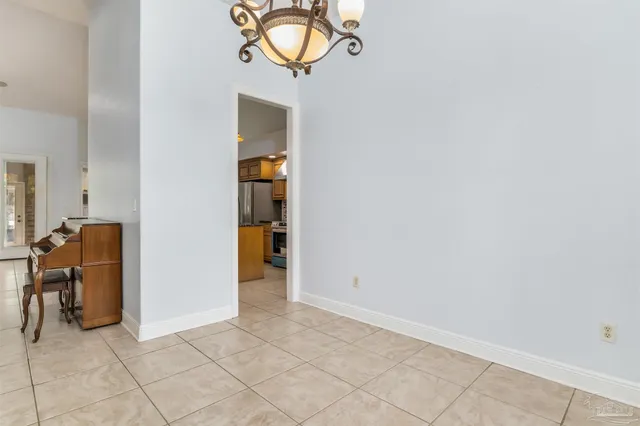a view of a dining room with furniture and chandelier