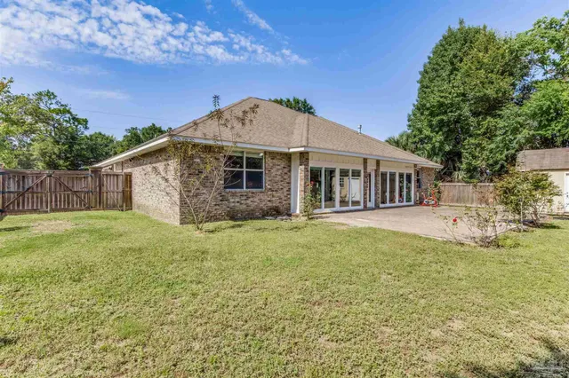 front view of a house with a large window and a yard