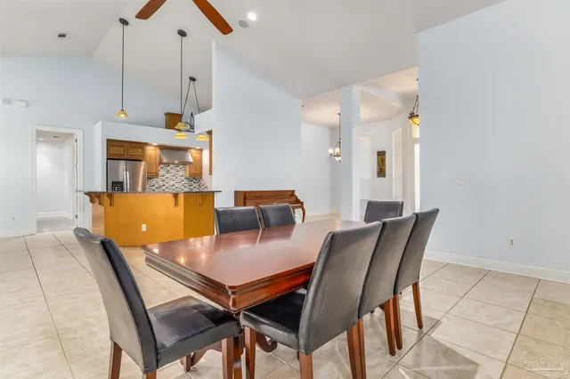 a dining room with furniture and a chandelier