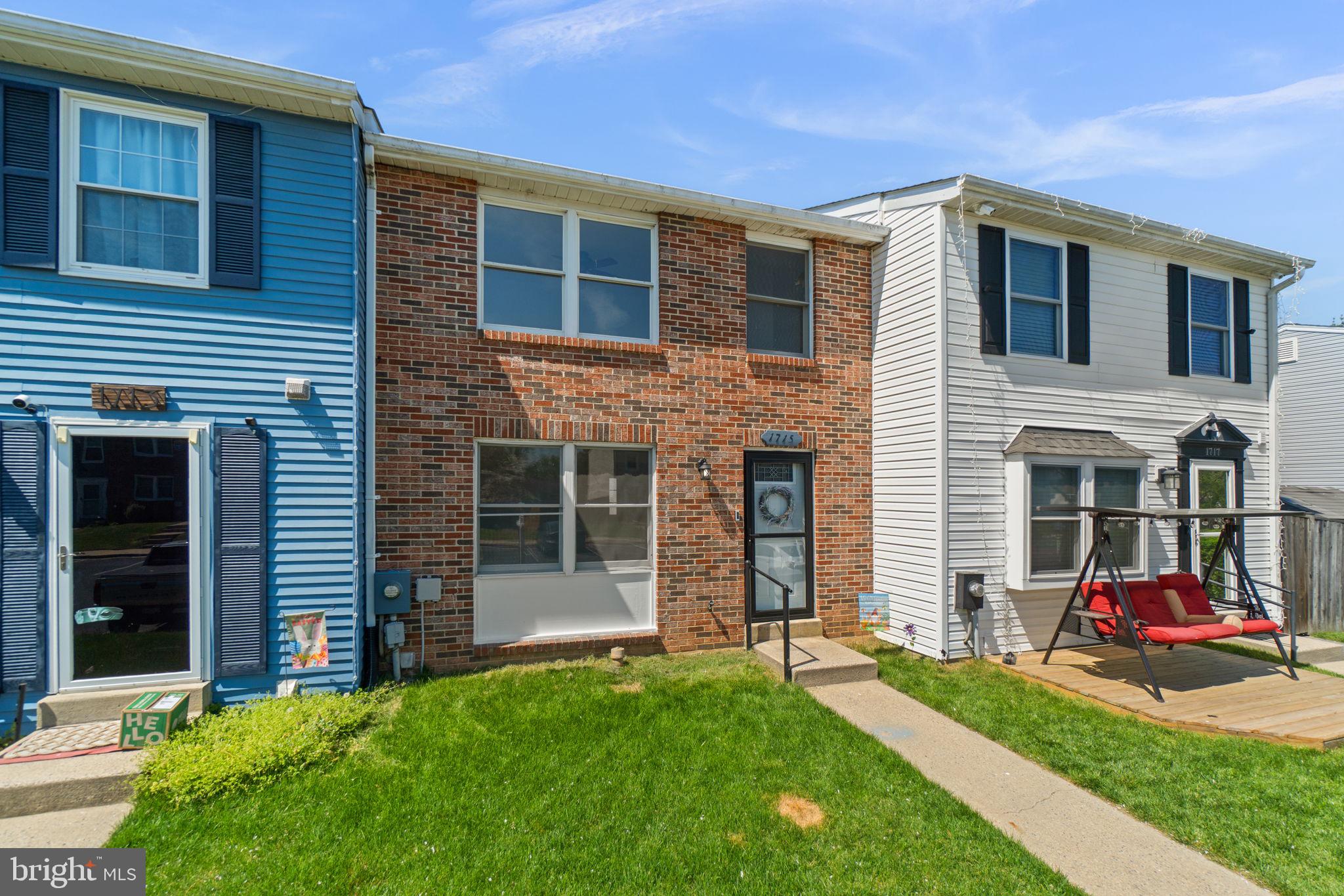 1715 Country Court Frederick, MD 21702 - Photo 2 of 31 a front view of a house with a yard and porch