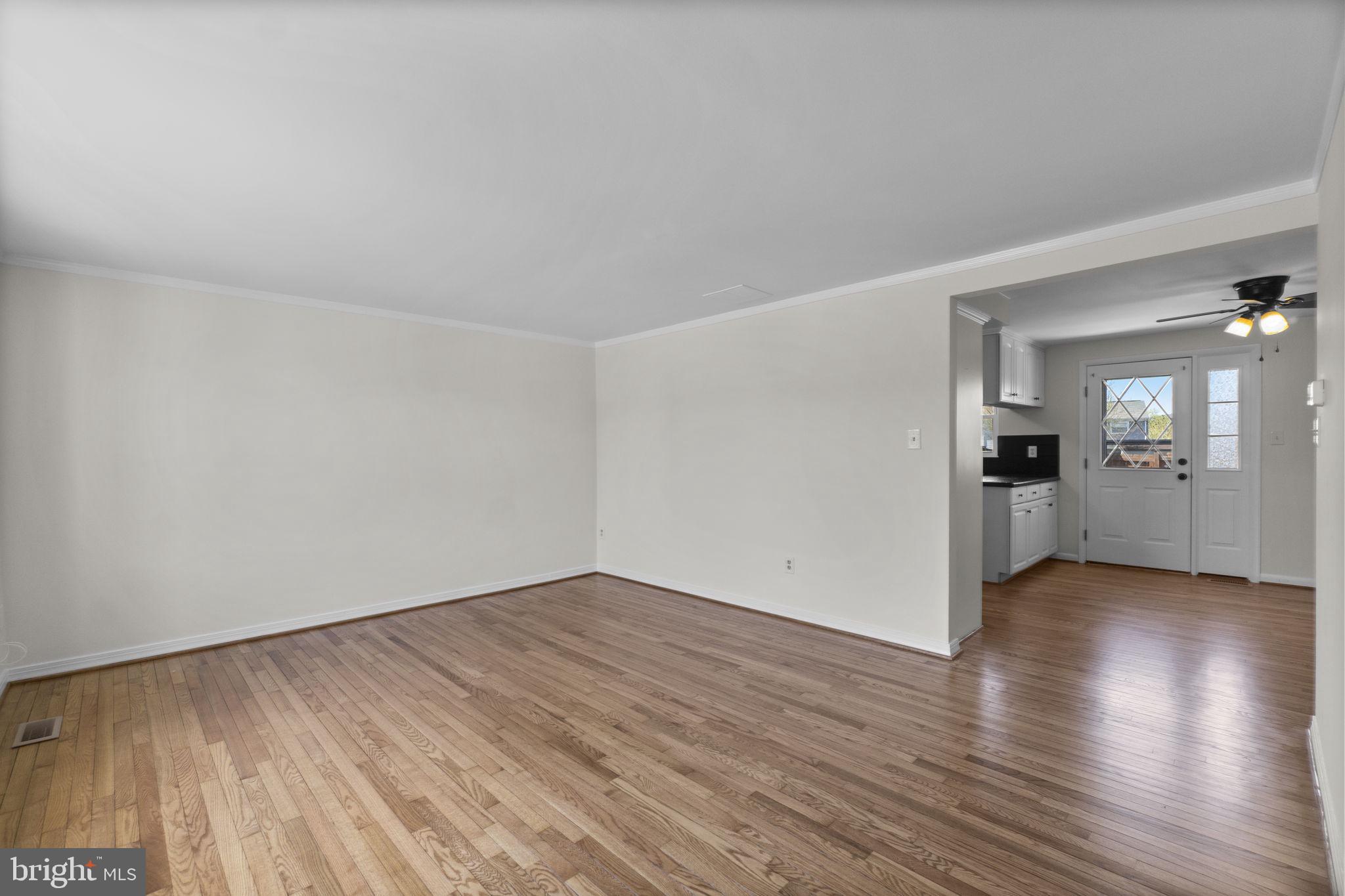 1715 Country Court Frederick, MD 21702 - Photo 3 of 31 an empty room with wooden floor and windows