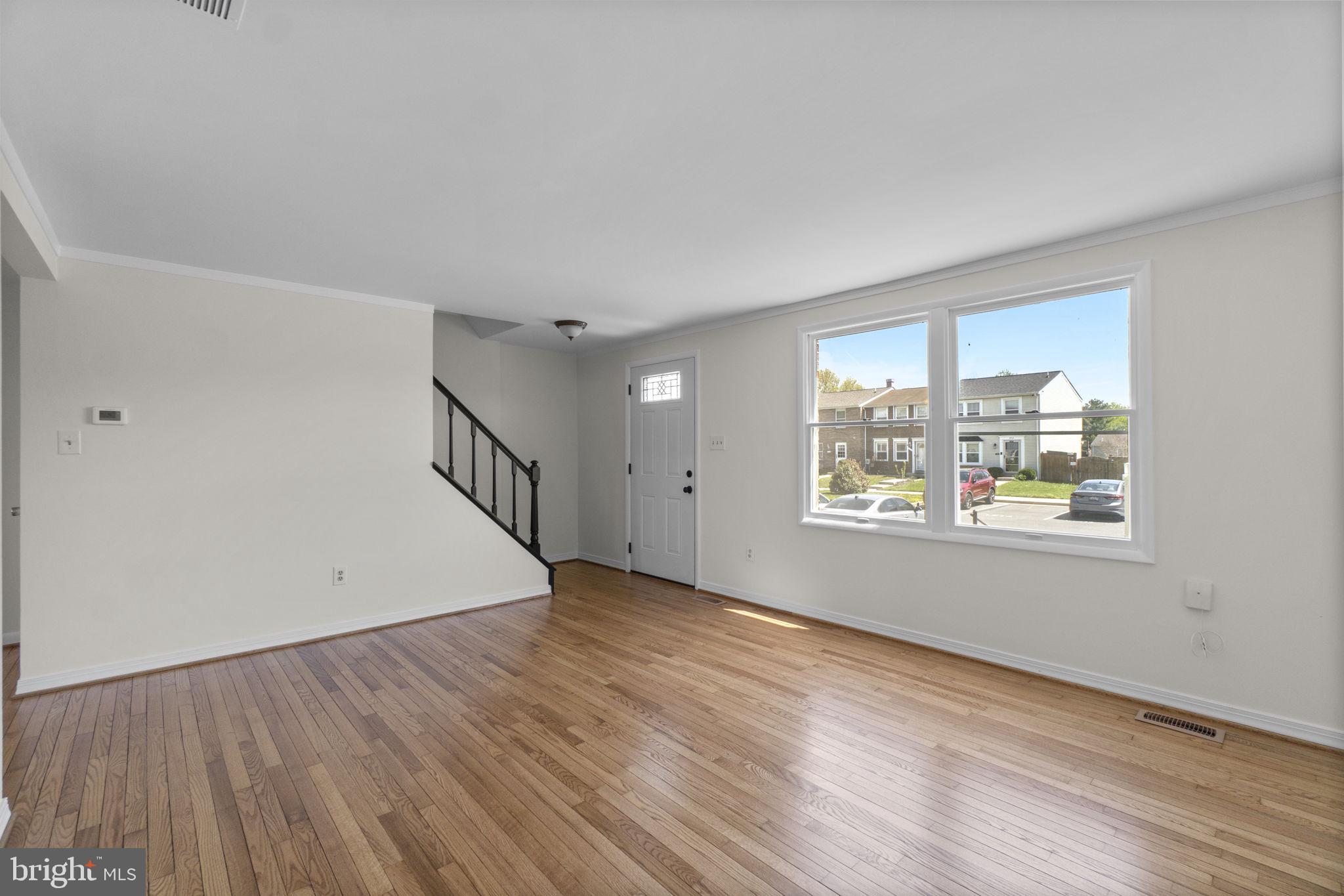 1715 Country Court Frederick, MD 21702 - Photo 5 of 31 a view of an empty room with wooden floor and a window