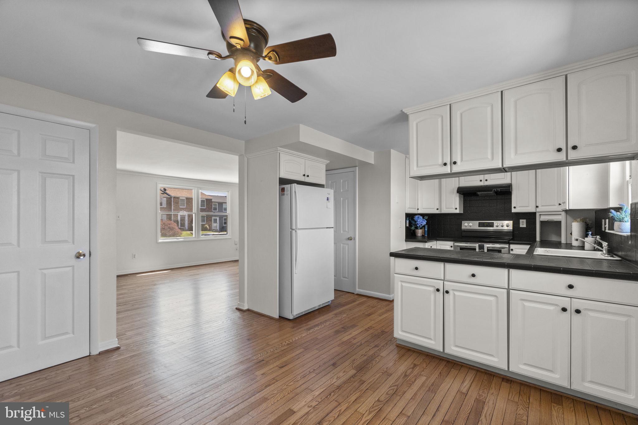 1715 Country Court Frederick, MD 21702 - Photo 7 of 31 a kitchen with stainless steel appliances granite countertop a stove a sink dishwasher and a refrigerator with wooden floor