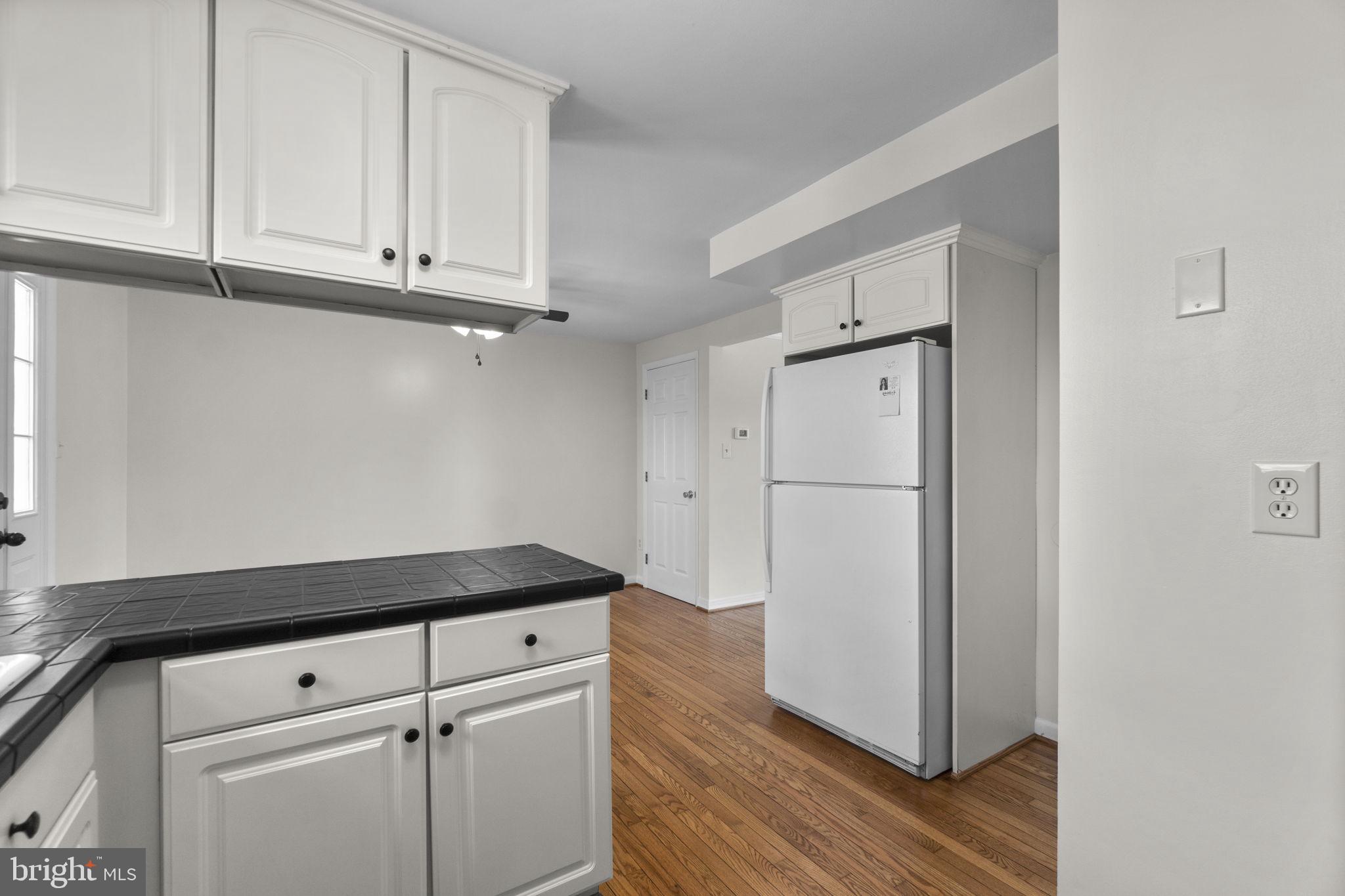 1715 Country Court Frederick, MD 21702 - Photo 9 of 31 a kitchen with a refrigerator and cabinets