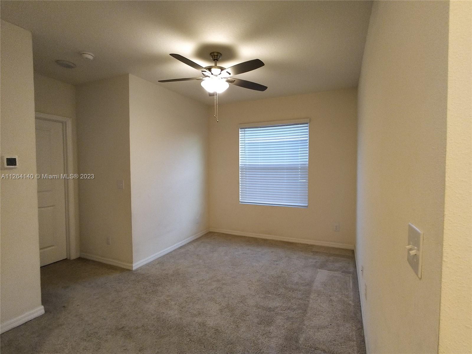 8749 Falling Blue Place Riverview, FL 33578 - Photo 19 of 51 a view of an empty room with a fan