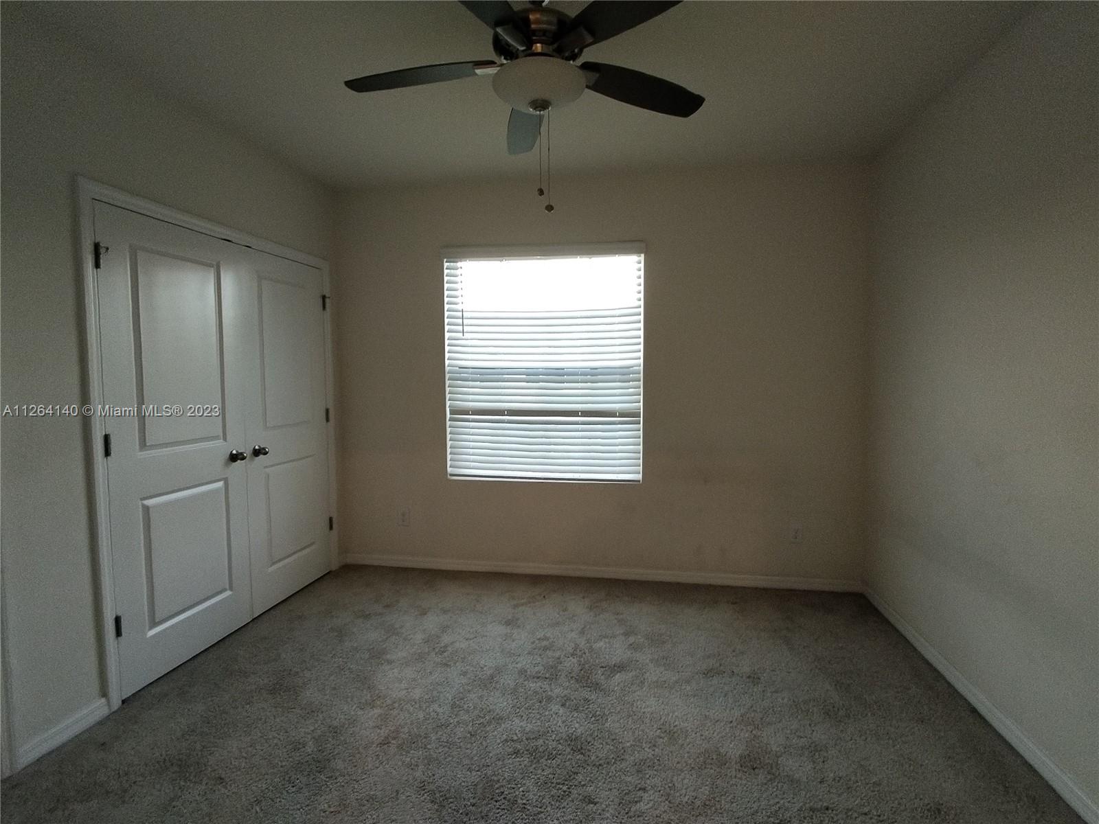 8749 Falling Blue Place Riverview, FL 33578 - Photo 20 of 51 an empty room with a window and a fan